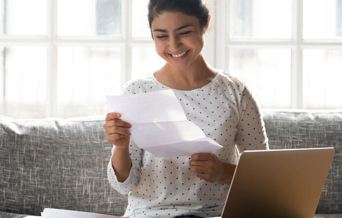 College student holding admissions letter.