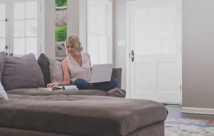 female_student_studying_on_couch_with_laptop_at_home_1_261_717x440.jpg