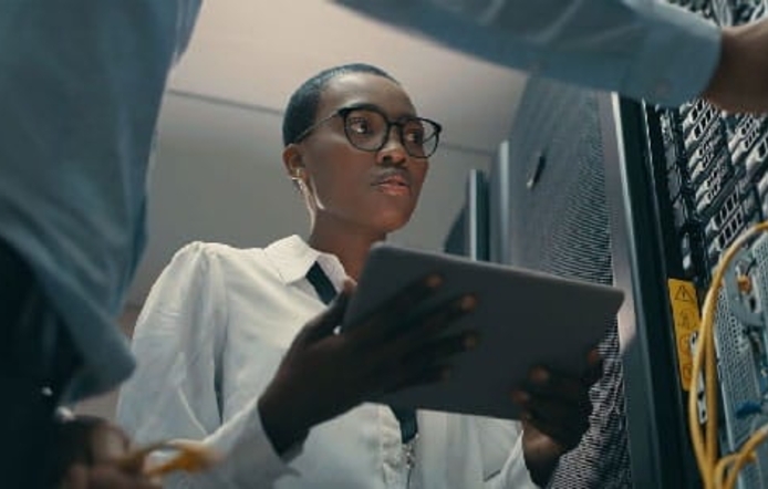 a woman checking a computer server