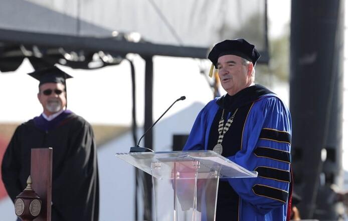 Chancellor Andrews speaking at commencement.