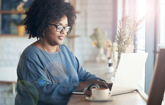 Online student on laptop in front of window