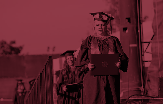Umass Global Graduate Walking On Stage