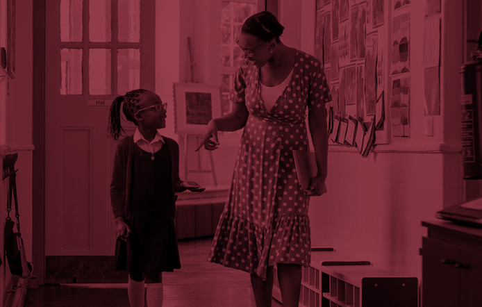 a school counselor talking to a girl student while walking