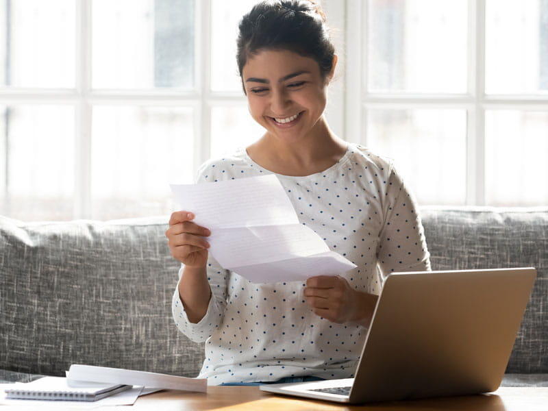 College student holding admissions letter.