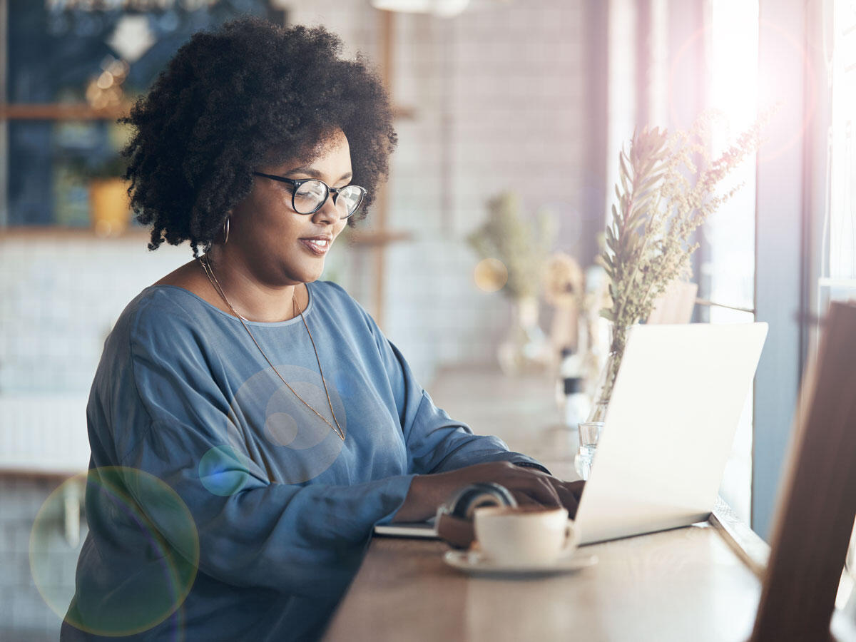 Online student on laptop in front of window
