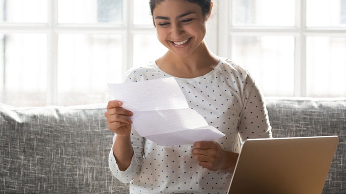 College student holding admissions letter.