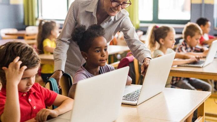 teacher teaching some elementary students