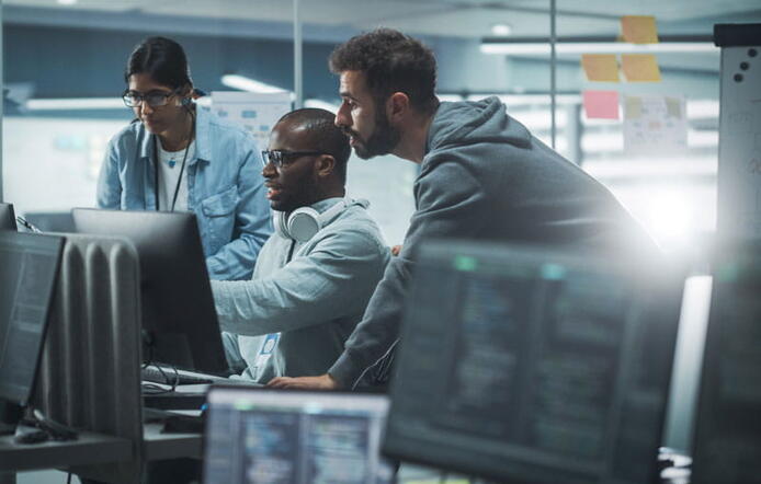 Students gathered in front of a computer